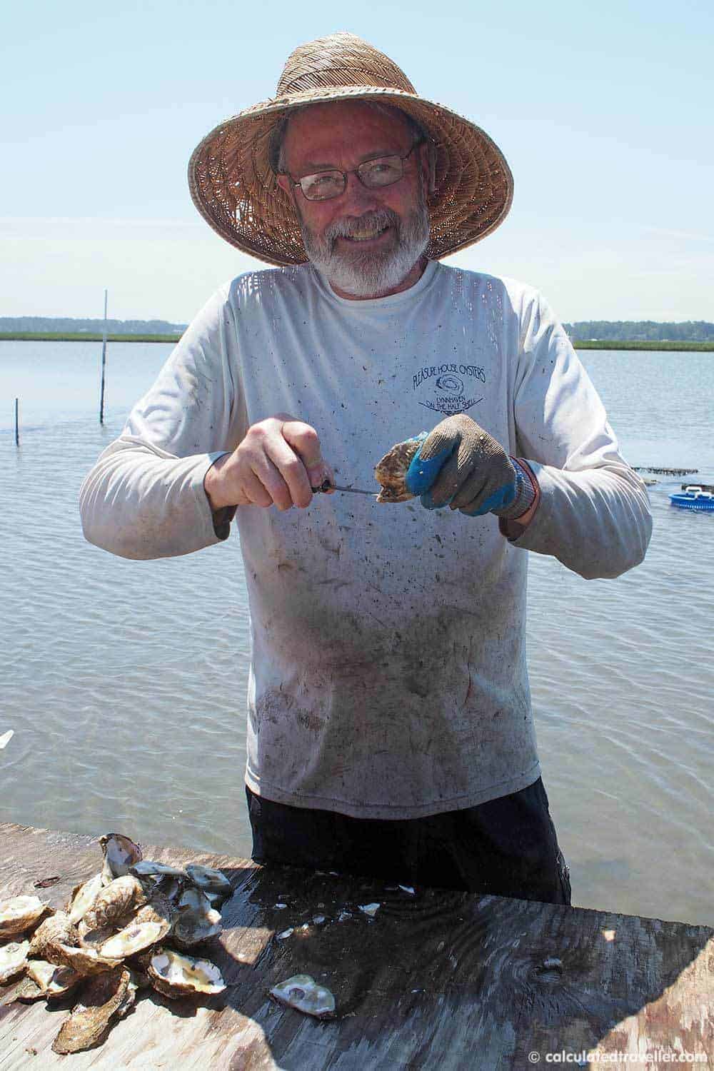 A Pleasure House Oyster Tour in Lynnhaven Virginia - Captain Lee shucking oysters for us.