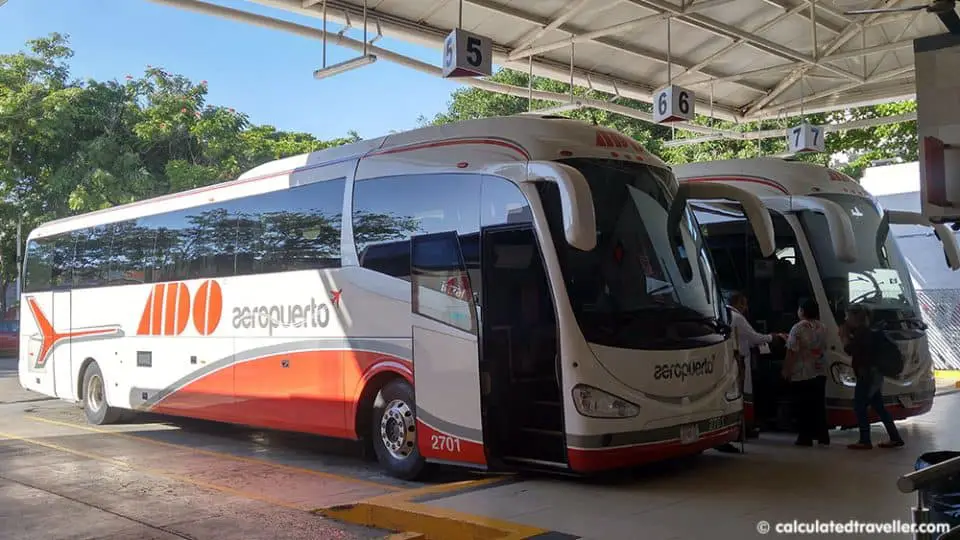 A Guide to Riding Public Transportation in Playa Del Carmen Mexico - Cancun Airport Bus parked at the ADO Bus Terminal in Playa del Carmen