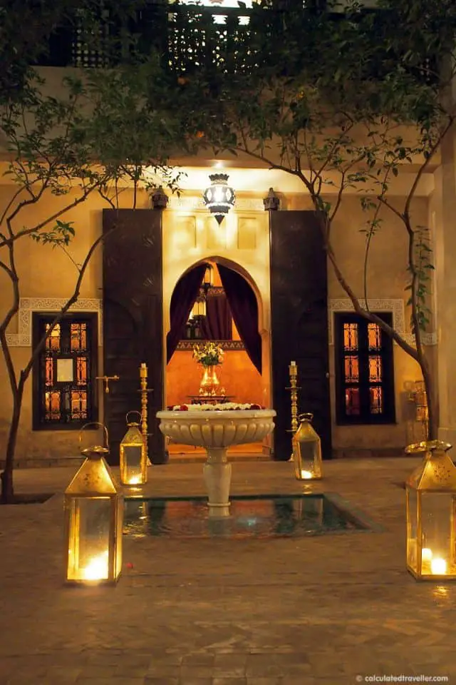 courtyard at night lit by candles