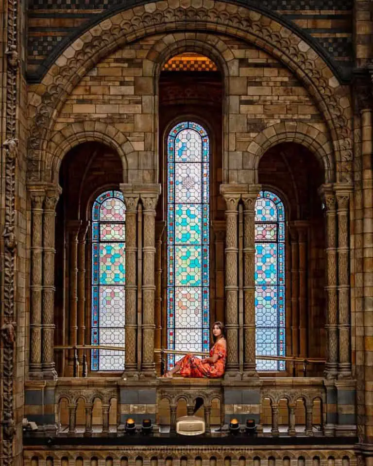 Interior view of girl sitting in the archway of a church