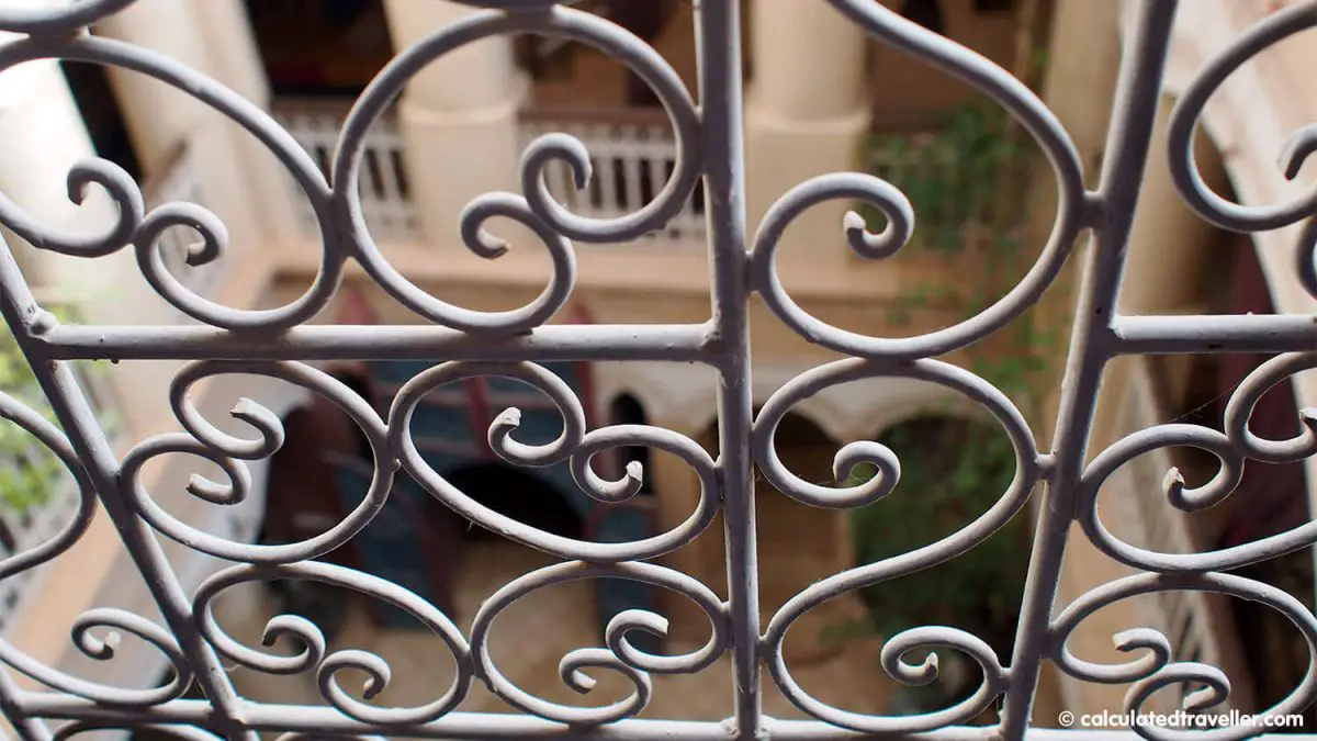 View of the inner courtyard through ornate metal bars of our room