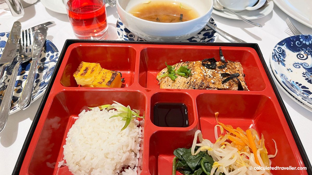 Bento box with steamed white rice, tamagoyaki, broiled salmon, and miso soup