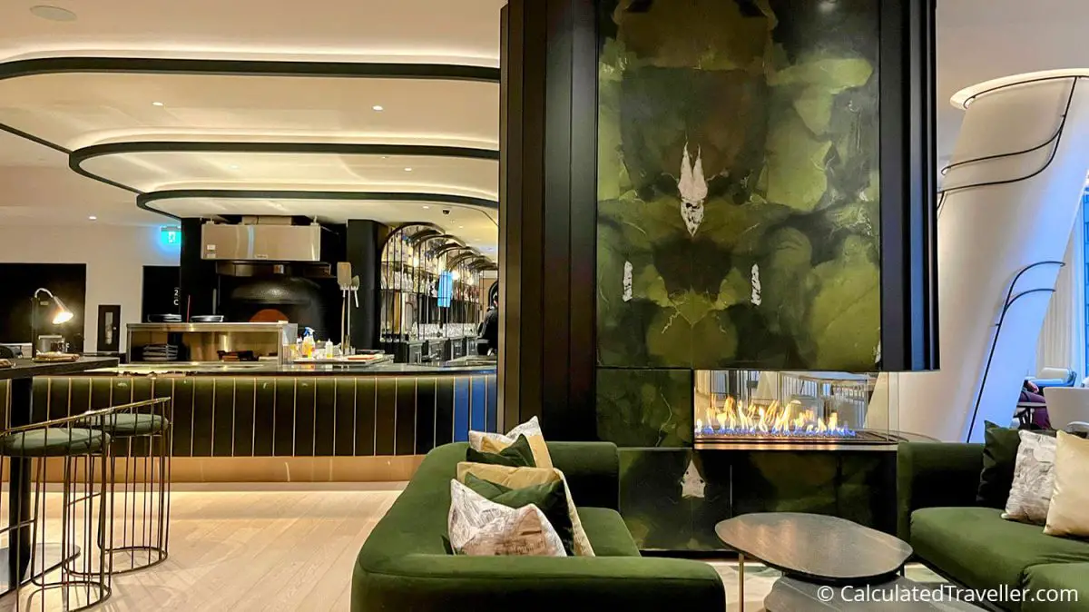 Interior view of the fireplace, seating area and bar of Dia Restaurant