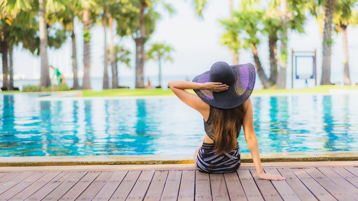 woman by pool at all inclusive resort